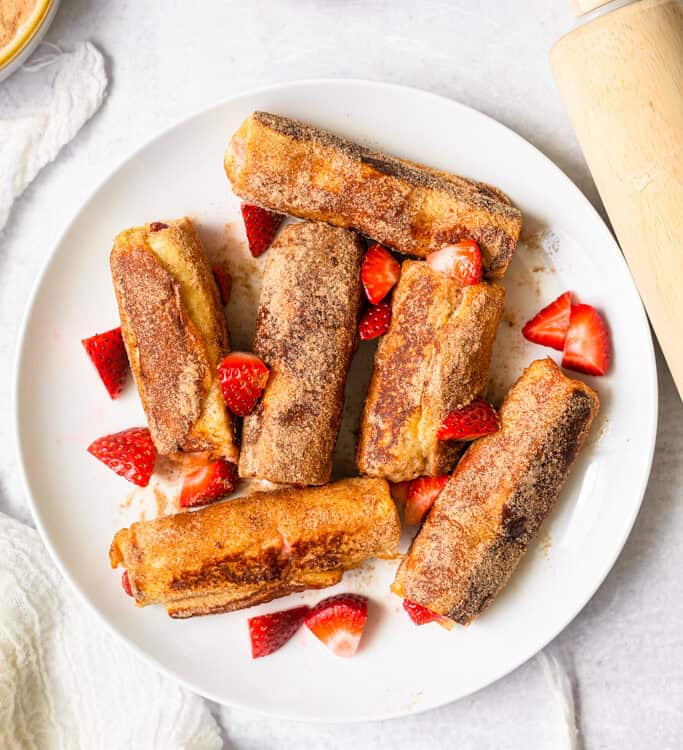 Strawberries and Cream French Toast Roll Ups on a plate.
