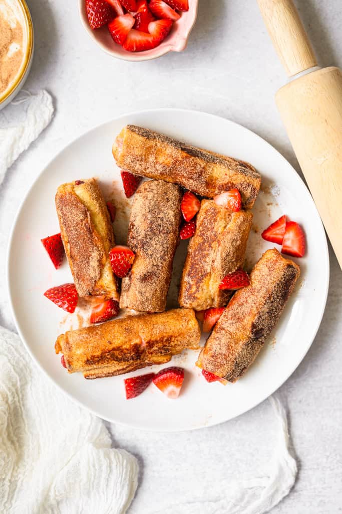 Strawberries and Cream French Toast Roll Ups on a plate.