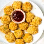 Monterey Jack Chicken Poppers on a tray with a side of BBQ sauce.