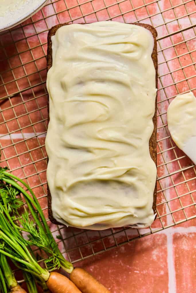 Carrot cake loaf topped with cream cheese icing.