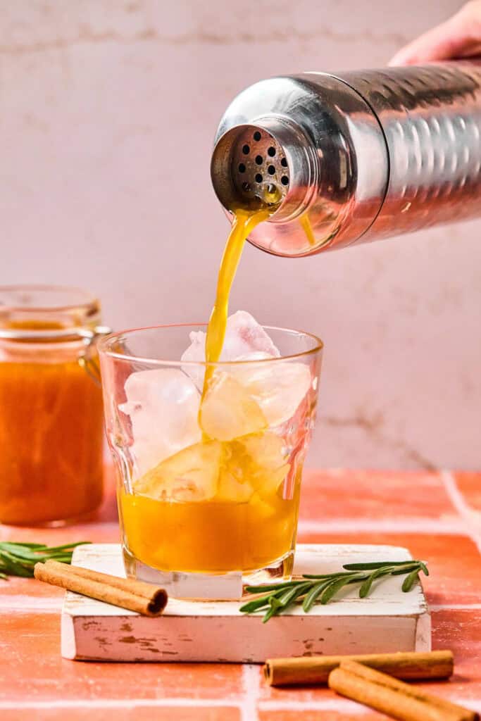 Smashing Pumpkin Cocktail being poured in a glass.
