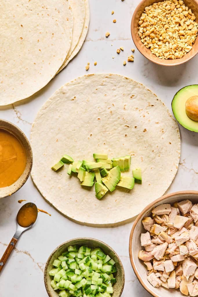 Tortilla with sliced avoacdo on half.