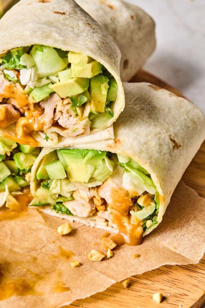 Zoomed in view of Peanut chicken crunch wraps cut in half.