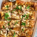 Goat Cheese Chicken Puff Pastry Pizza on a cutting board.