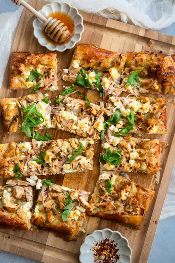 Goat Cheese Chicken Puff Pastry Pizza on a cutting board.