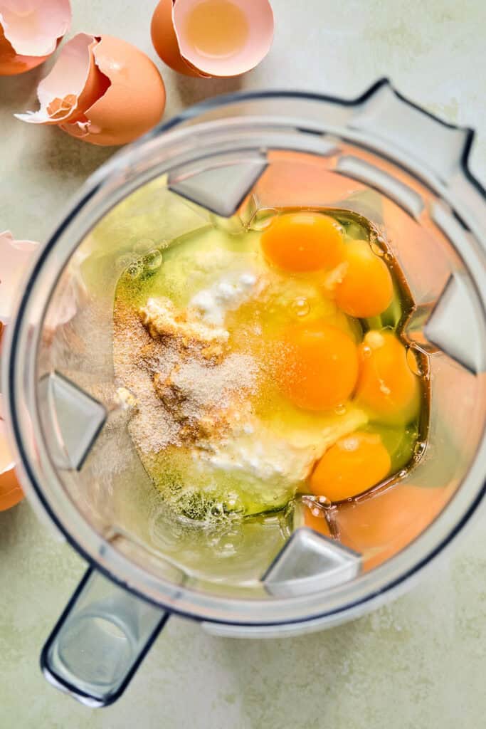 Eggs, cottage cheese, and seasonings in a food processor bowl.