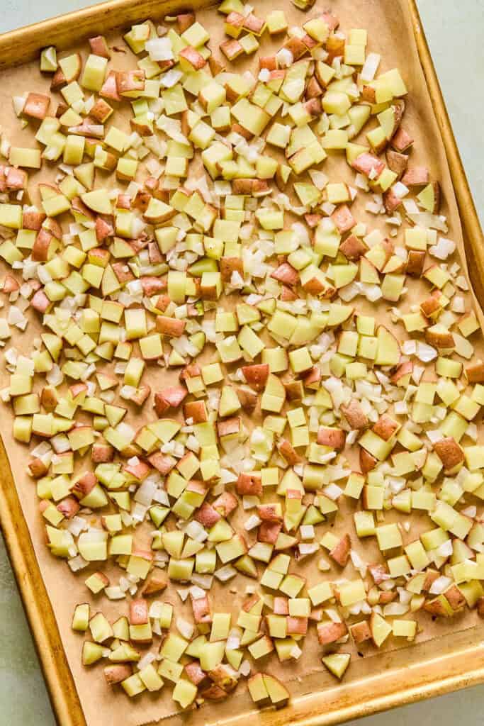 Diced potatoes and onions on a tray.