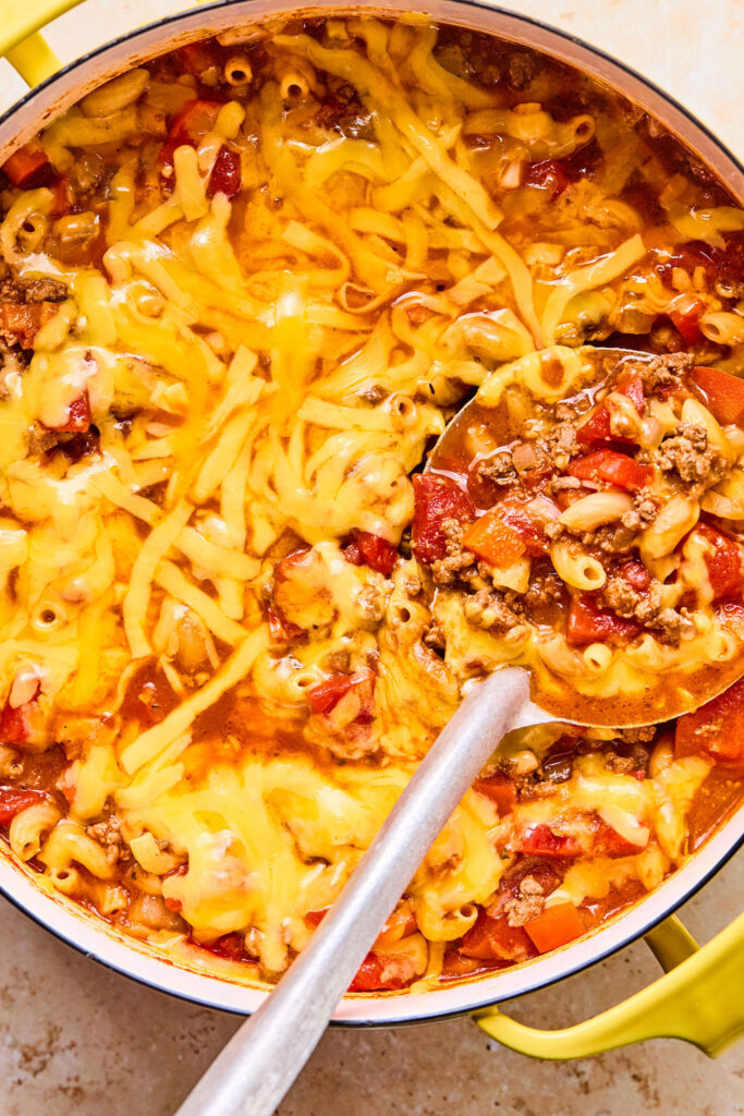 American Goulash topped with cheese in a pot.