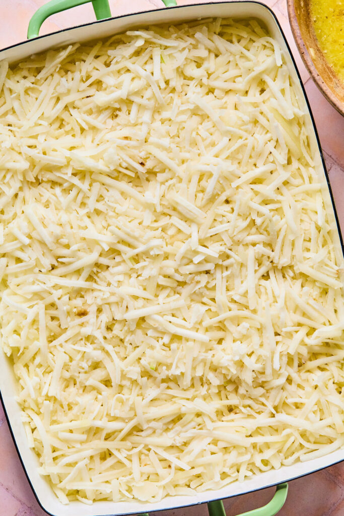 Shredded potatoes in a baking dish.