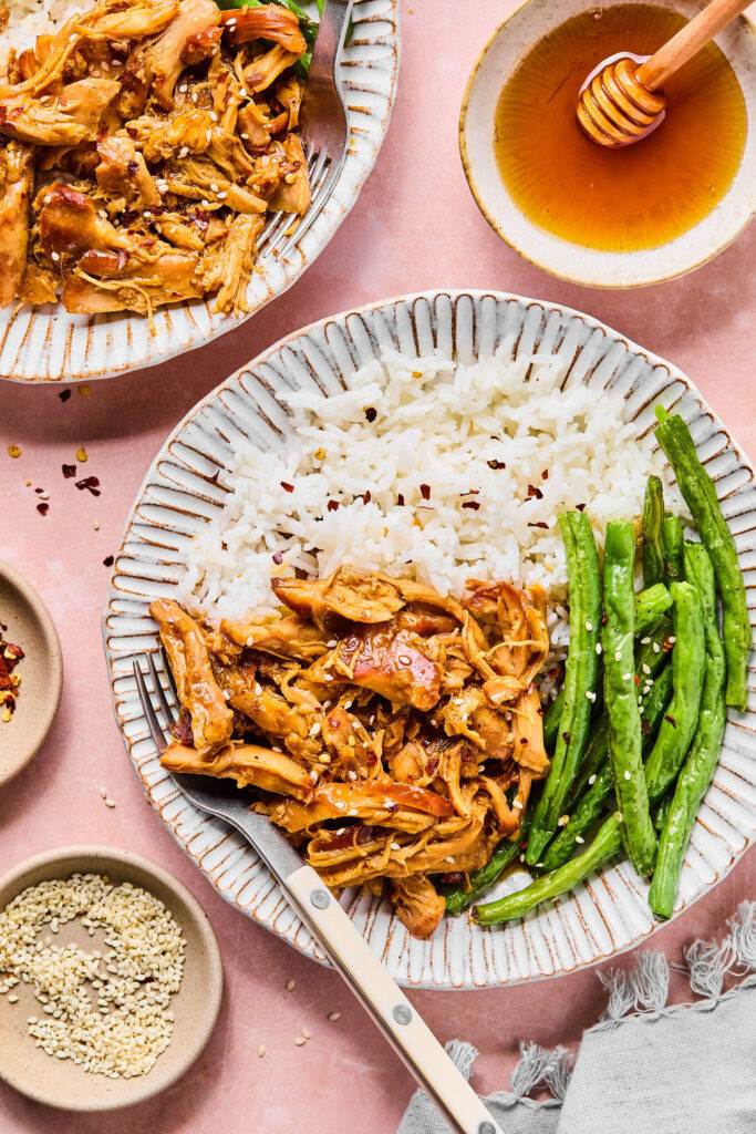 Crockpot Honey Garlic Chicken on a plate with rice and green beans.