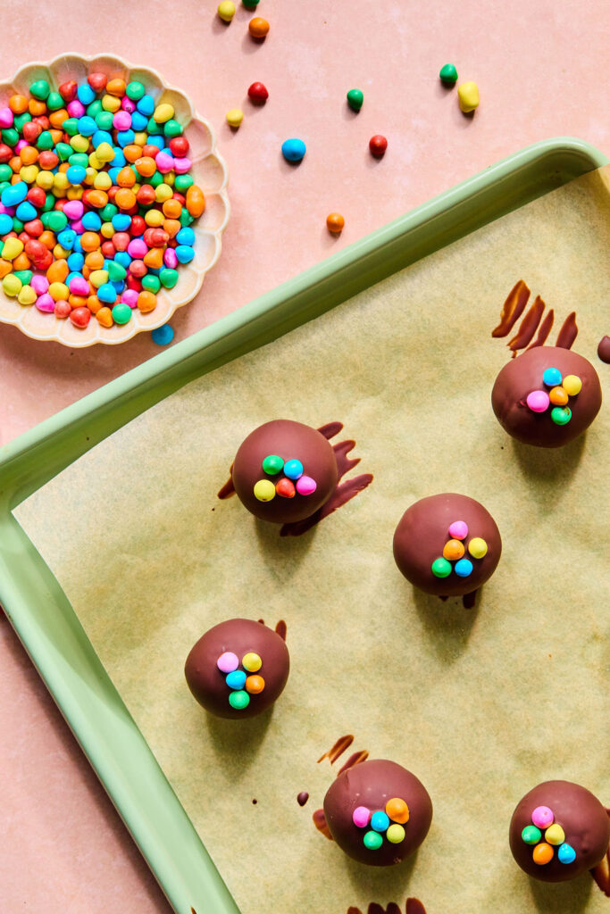Cosmic Brownie Protein Bites on a baking sheet wth paprchment paper.