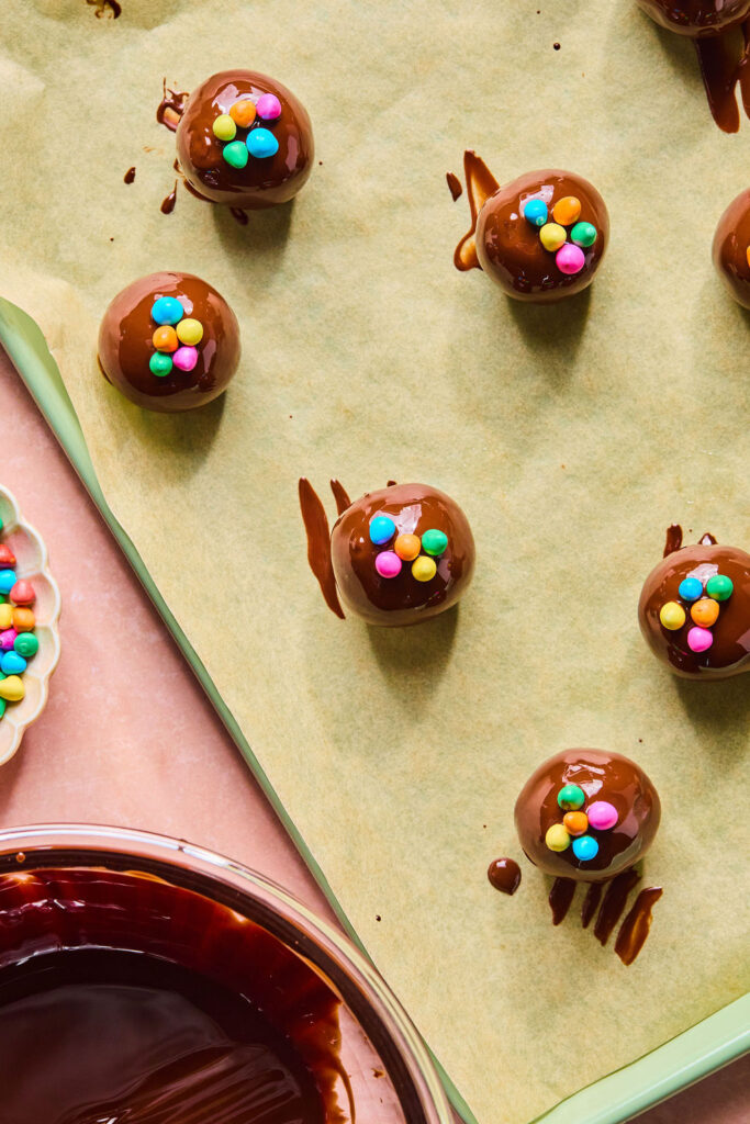 Cosmic Brownie Protein Bites on a baking sheet with parchment paper.