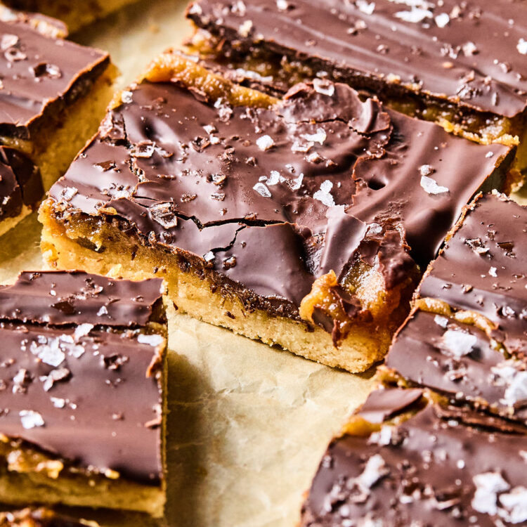 Salted Caramel Date Bars on parchment paper.