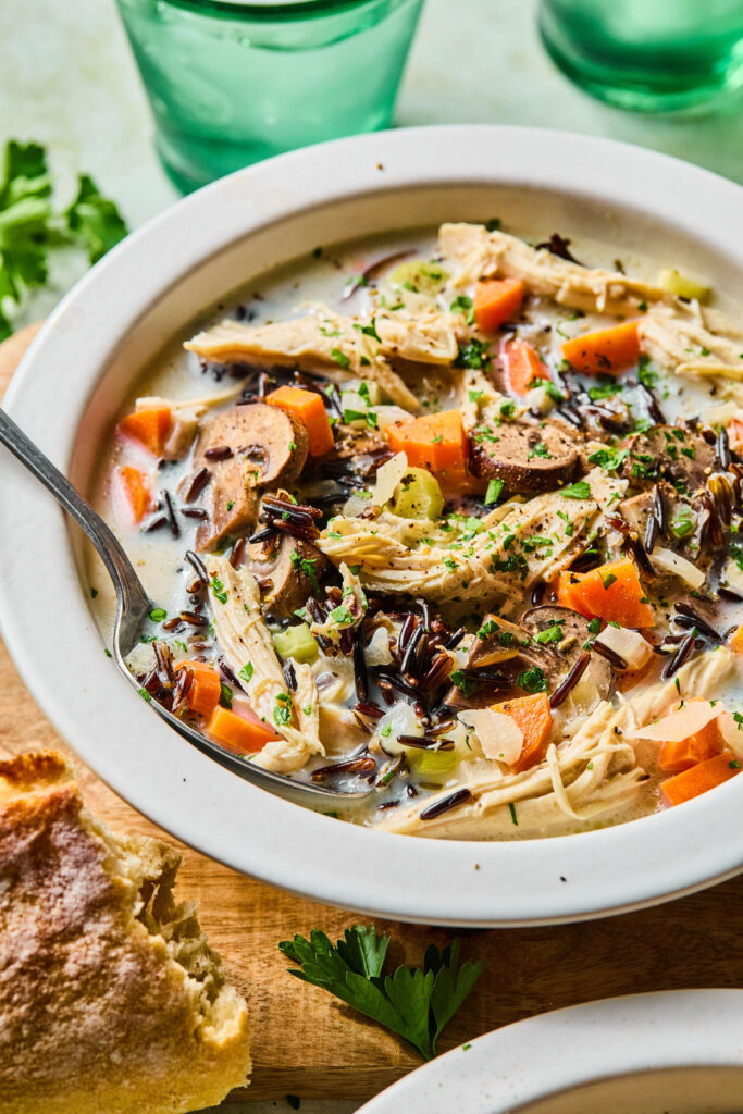 Crockpot Chicken and Wild Rice Soup in a bowl with a spoon.
