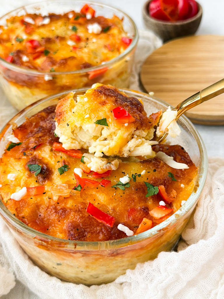 Mini Cheesy Red Pepper Hashbrown Breakfast Bakes in a bowl with a fork.
