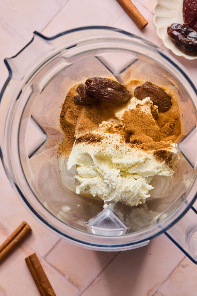 Ingredients for Cinnamon Vanilla Date Milkshake in a blender.
