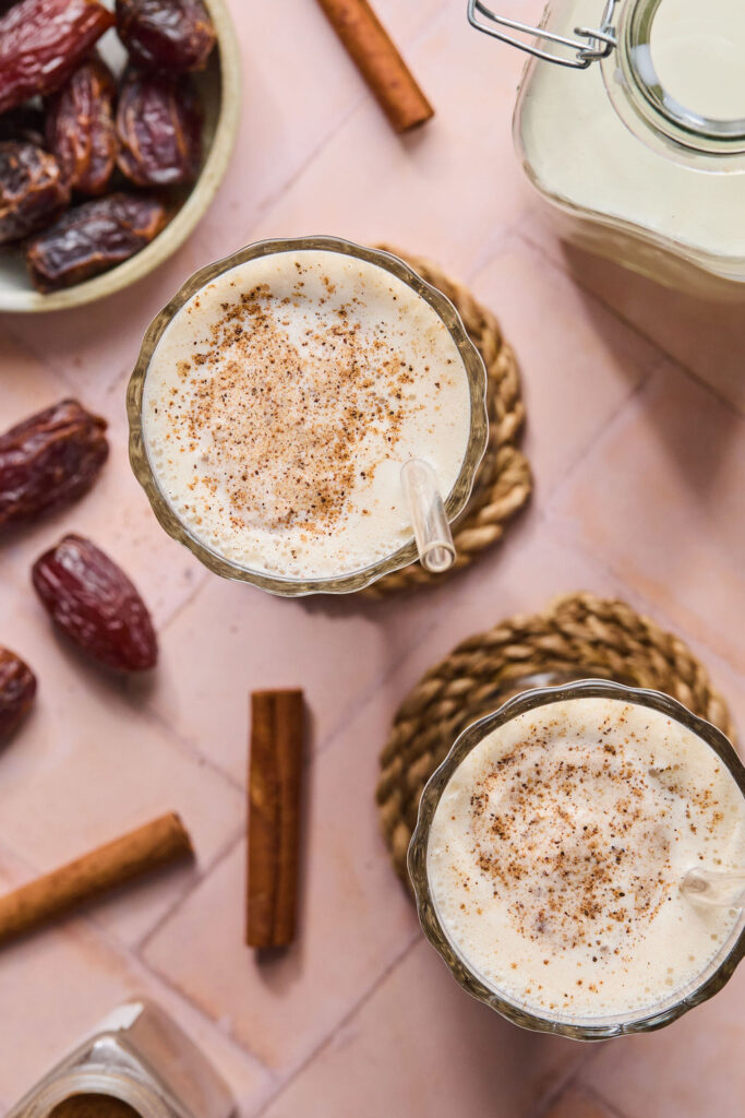 Cinnamon Vanilla Date Milkshake topped with cinnamon in glasses.