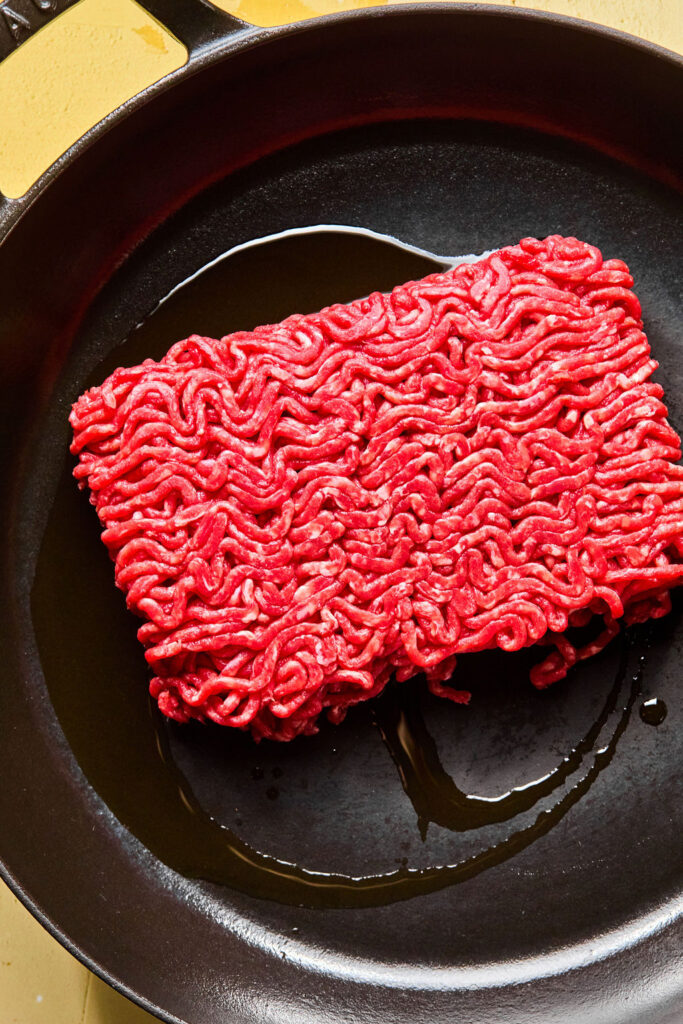 Raw ground beef in a skillet.
