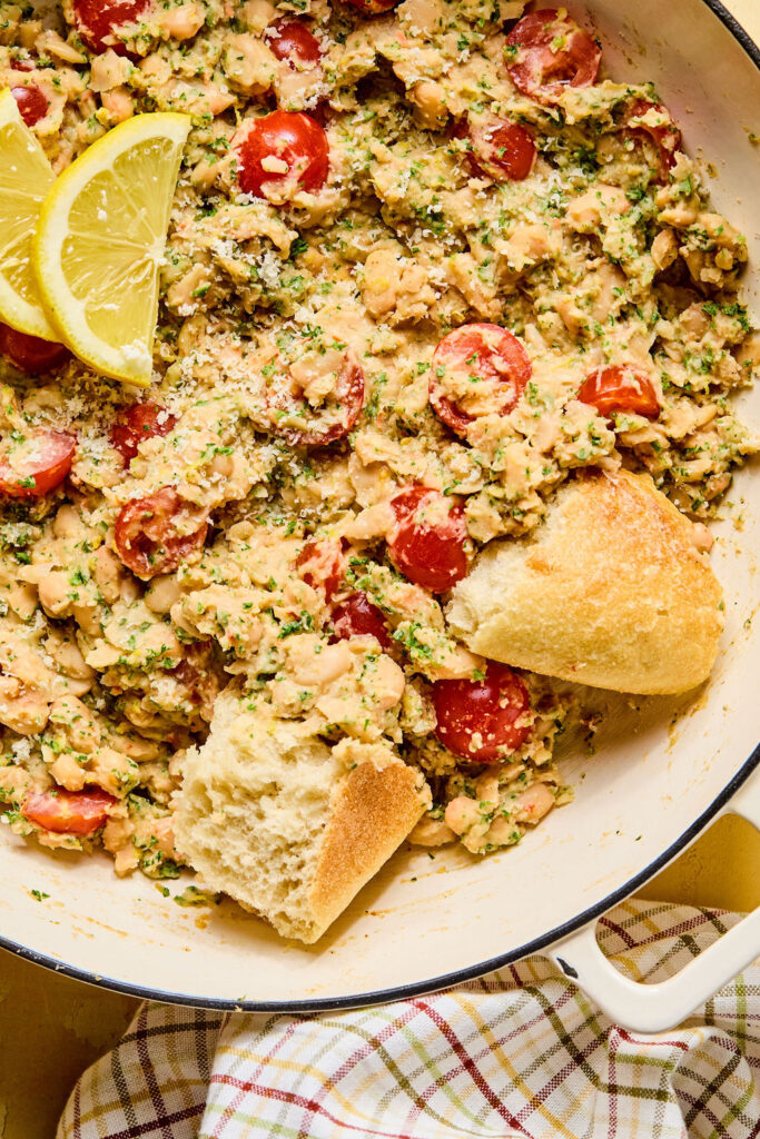 Zoomed in view of Lemon Garlic Parmesan White Beans in a skillet.