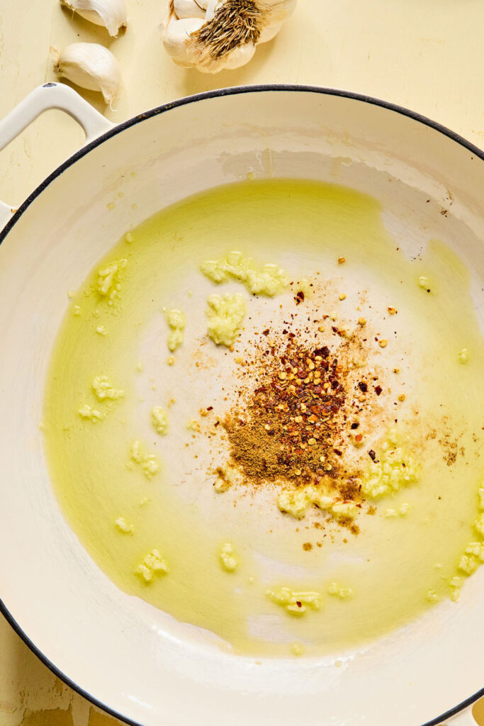 Olive oil, garlic, and spices in a skillet.
