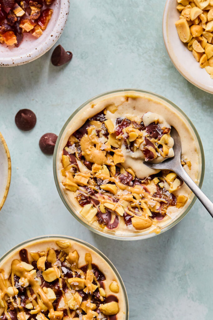 Snickers Blended Overnight Oats in a small jar with a spoon.