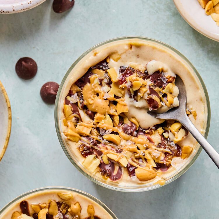Snickers Blended Overnight Oats in a small jar with a spoon.