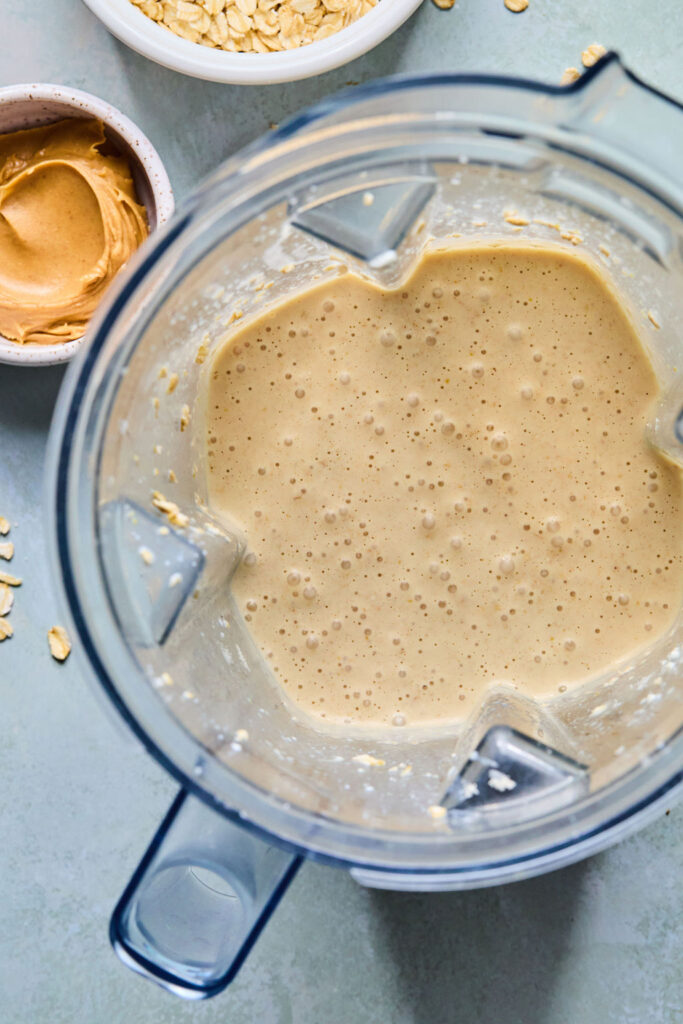 Snickers Blended Overnight Oats mixture blended together in a food processor bowl.