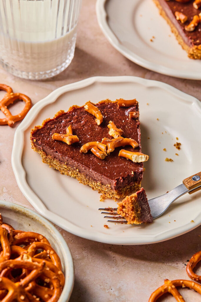 Milk Chocolate Pretzel Tart on a small plates with a fork.