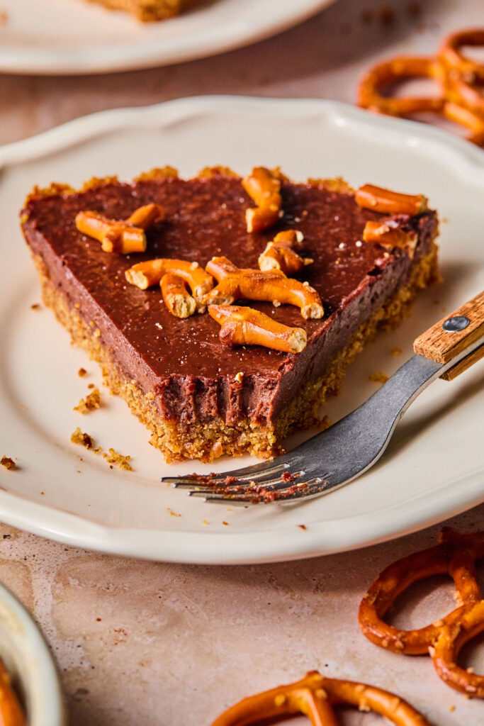 Milk Chocolate Pretzel Tart on a small plate with a fork.