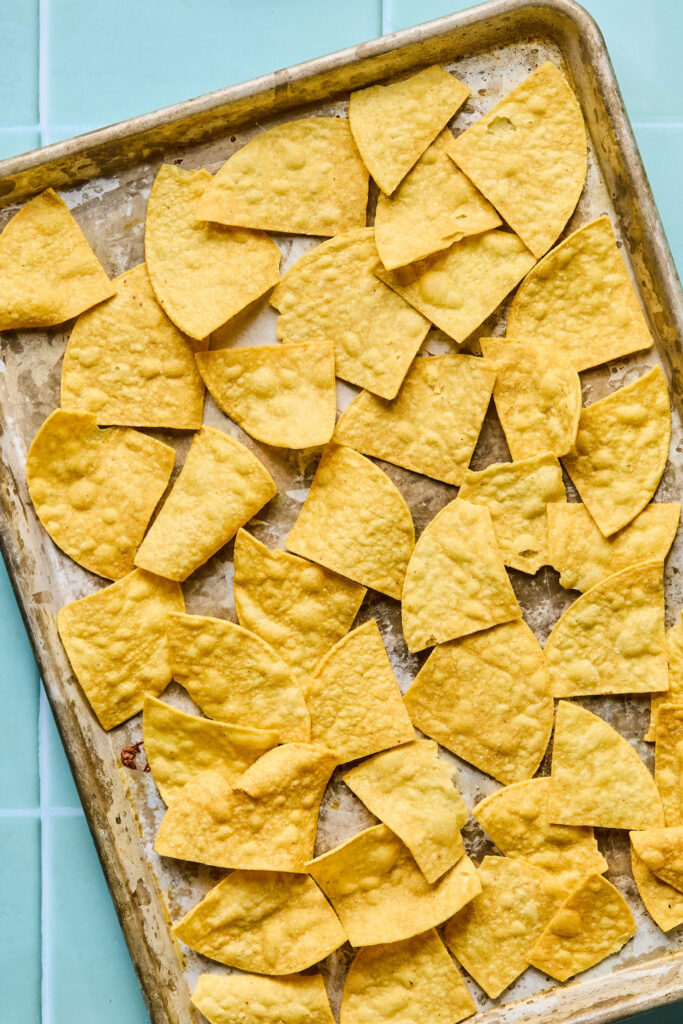 Tortilla chips on a baking sheet.