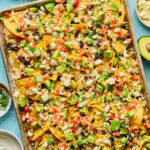 Chicken sheet pan nachos on a baking sheet.