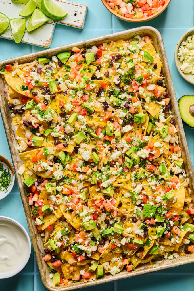 Chicken sheet pan nachos on a baking sheet.