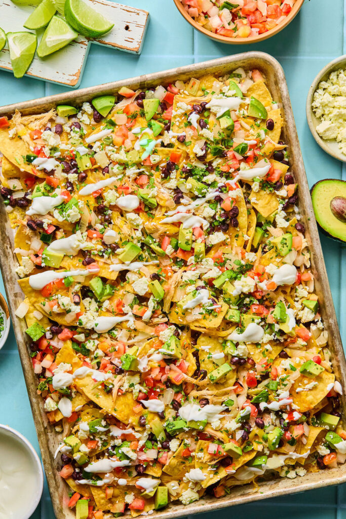 Chicken sheet pan nachos on a baking sheet.