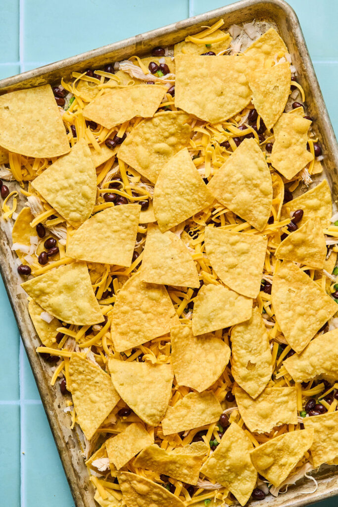 Additional chips on top of the ingredients on the sheet pan.