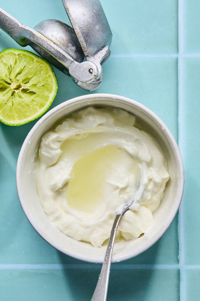 Sour cream mixture in a small bowl with a spoon.