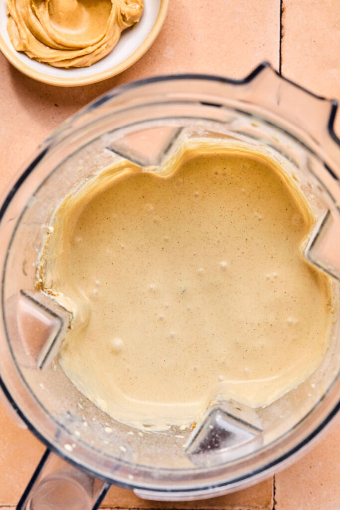 Ingredients for Peanut Butter Smoothie blended together in a blender.