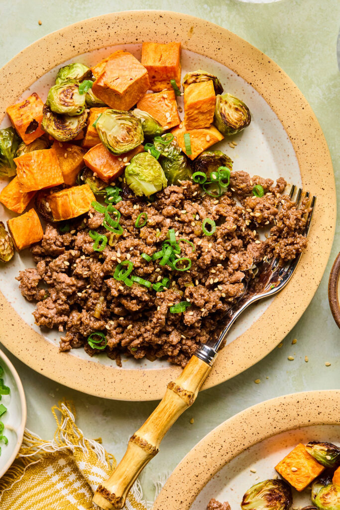 Sticky Korean BBQ Ground Beef and Veggies on a plate with a fork.