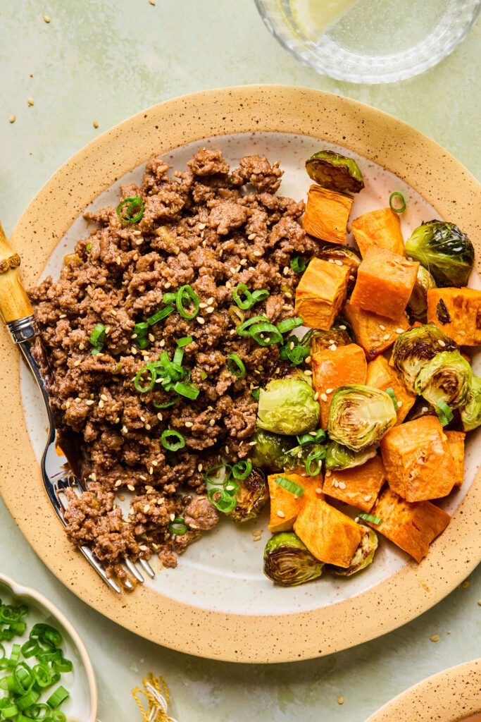 Sticky Korean BBQ Ground Beef and Veggies on a plate with a fork.