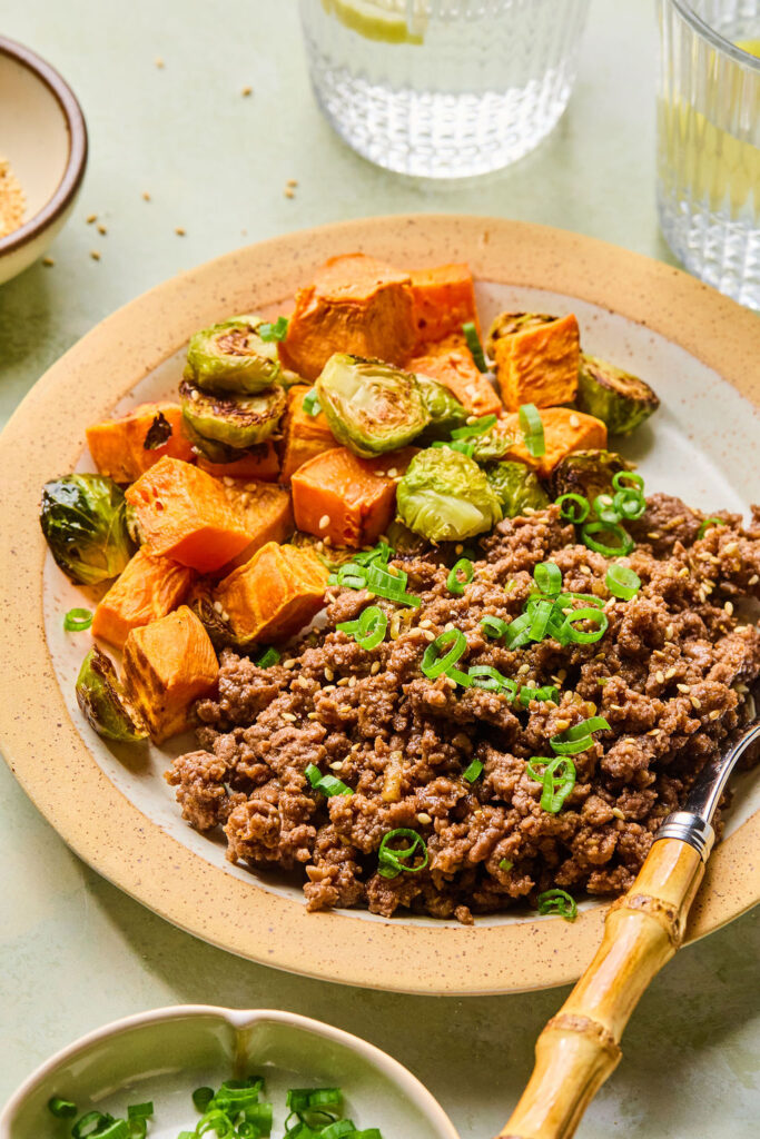 Sticky Korean BBQ Ground Beef and Veggies on a plate with a fork.
