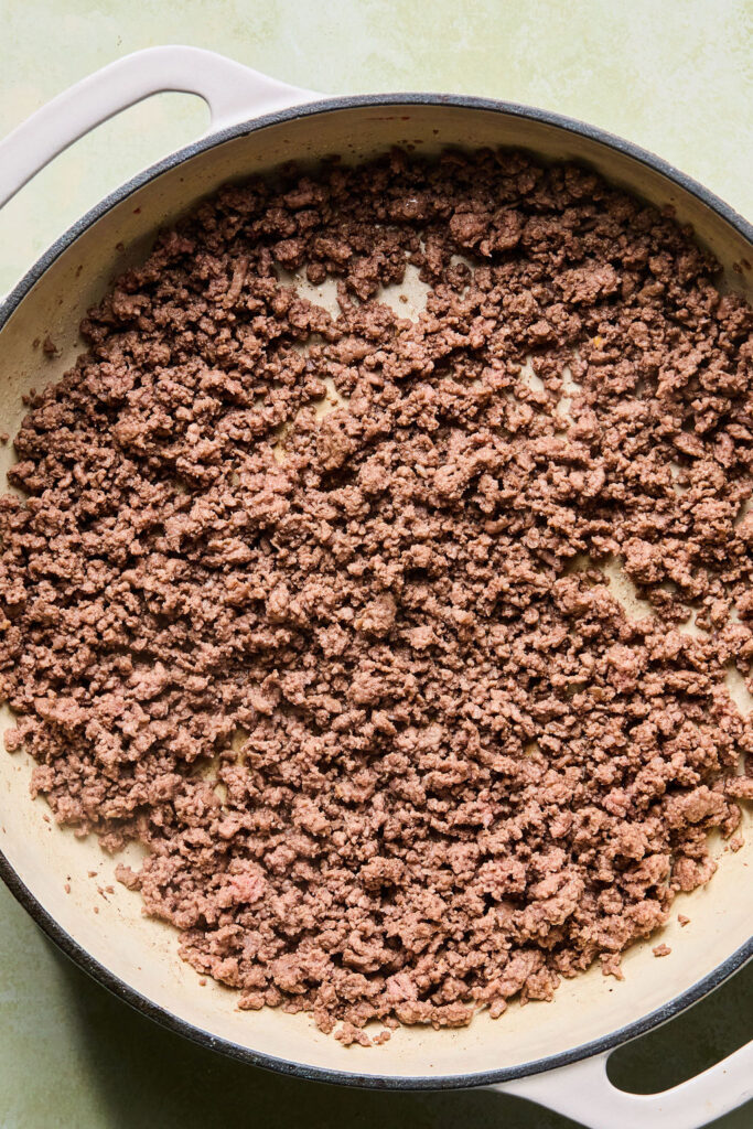 Cooked ground beef in a skillet.
