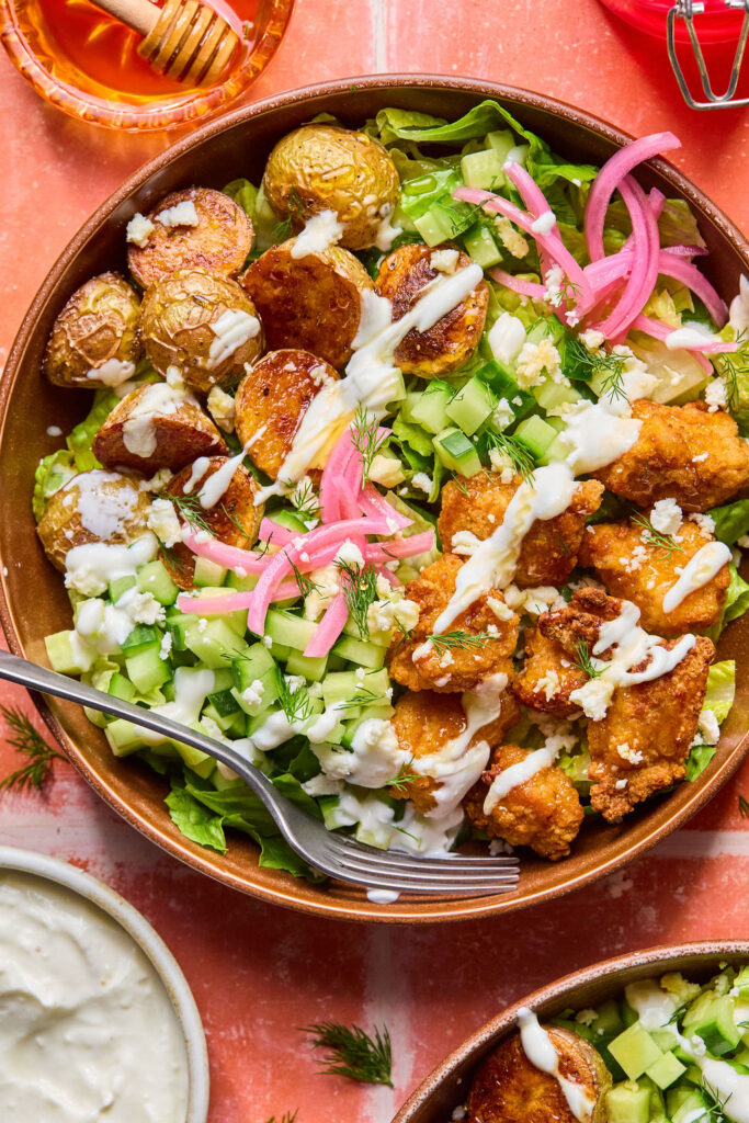 Crispy Chicken Bowls with Whipped Feta on a a salad.