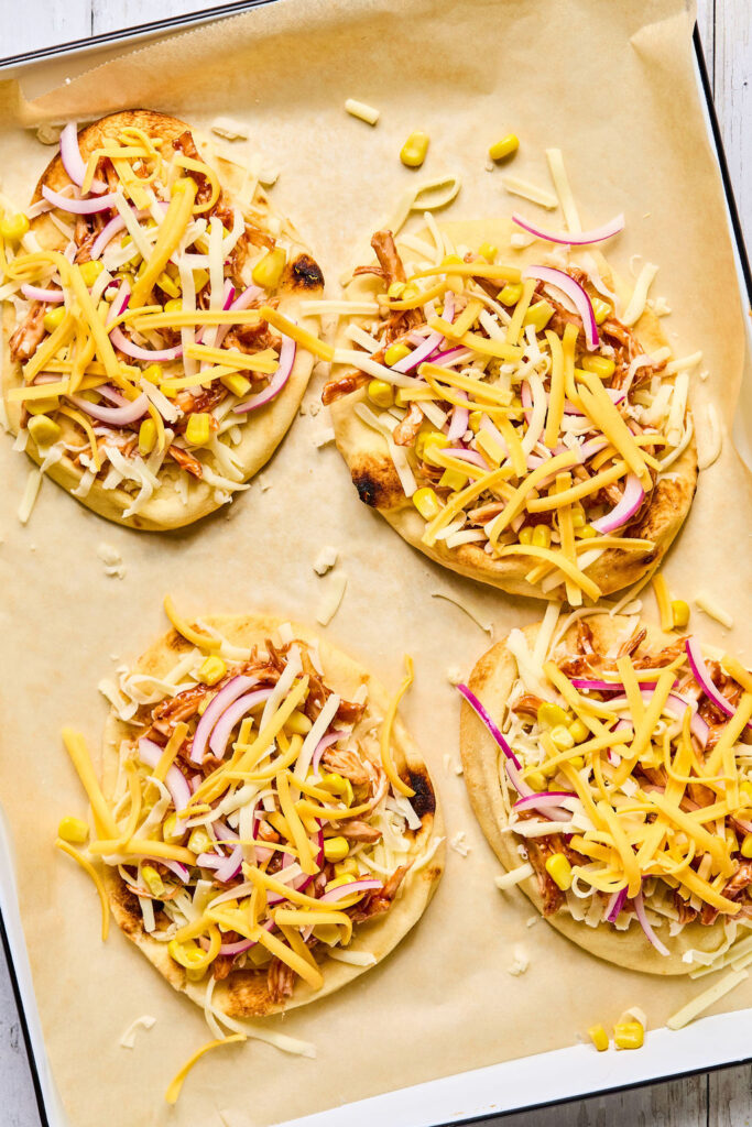 Sheet Pan BBQ Chicken Flatbread on a sheet pan before being baked.