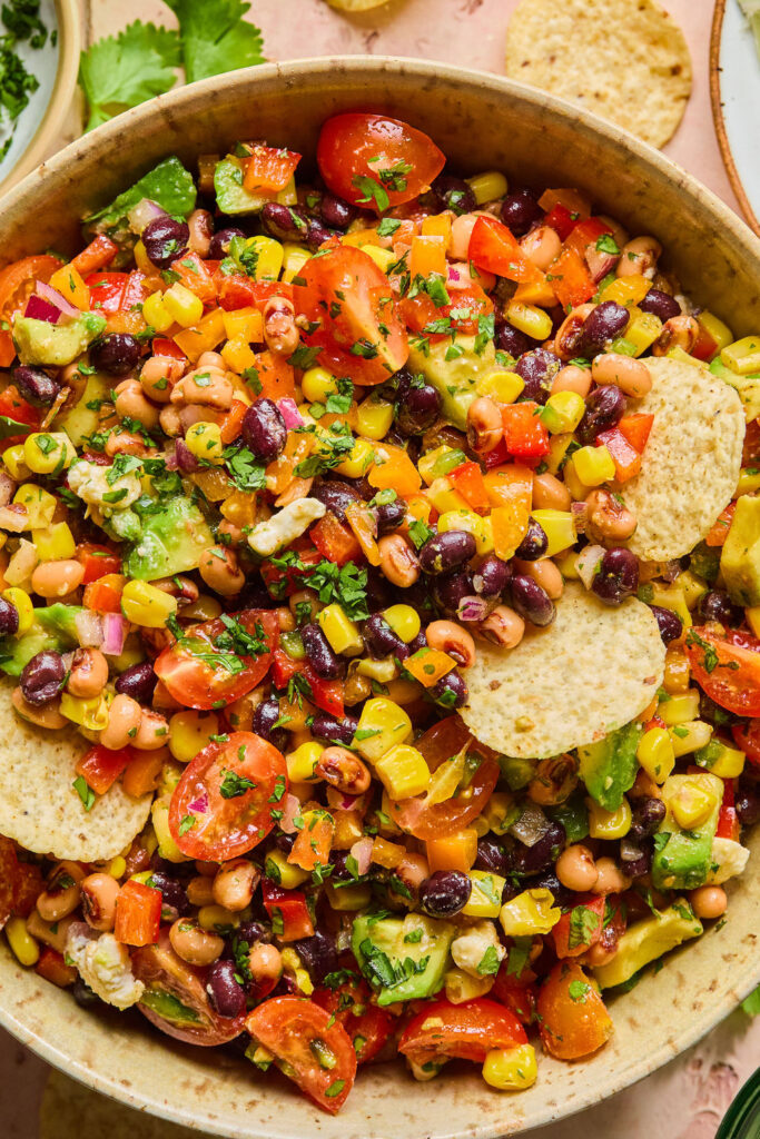 Rainbow Cowboy Caviar in a bowl with tortilla chips.