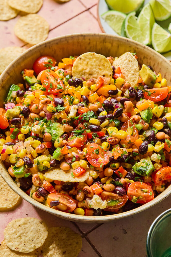 Rainbow Cowboy Caviar in a bowl with tortilla chips.