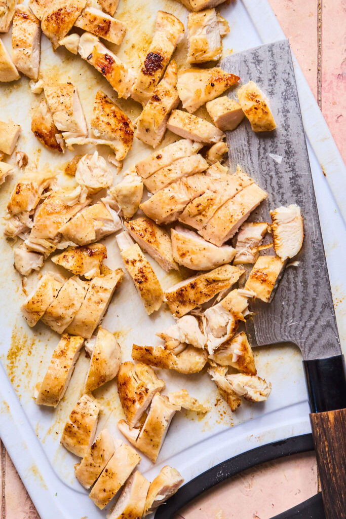 Sliced chicken on a cutting board.