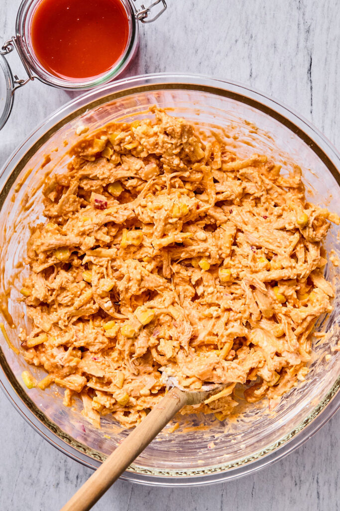 Buffalo Chicken Enchilada Bake mixed together in a bowl.