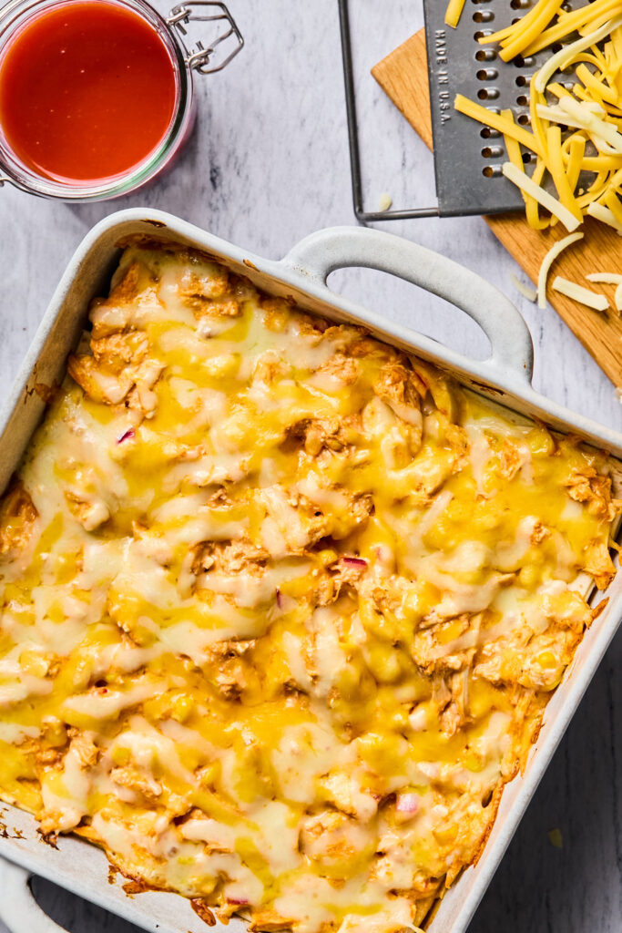 Buffalo Chicken Enchilada Bake in a square baking dish after being baked.