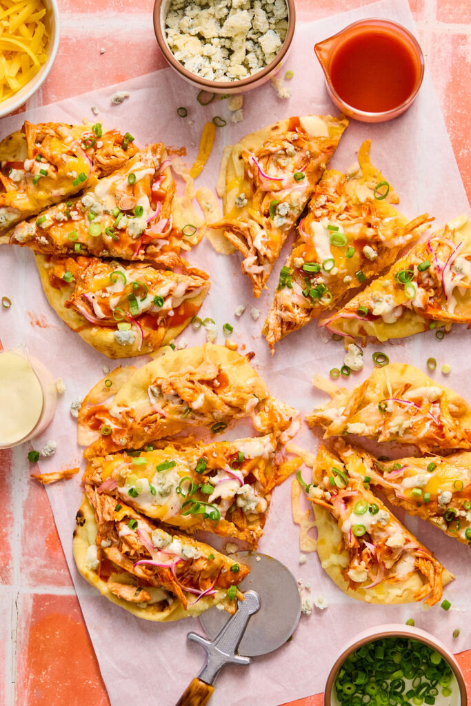 Buffalo Chicken Flatbreads on parchment paper.