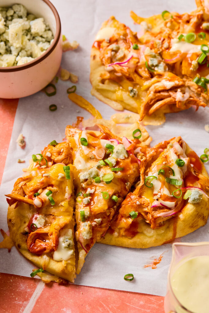 Buffalo Chicken Flatbreads on parchment paper.