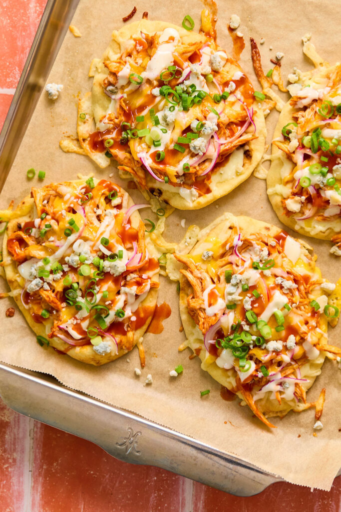  Buffalo Chicken Flatbread on a baking sheet with parchment paper.